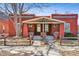 Charming red brick home with inviting front porch and well-maintained landscaping at 279 Delaware St, Denver, CO 80223