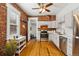 Cozy kitchen features stainless steel appliances, exposed brick wall, and hardwood floors at 279 Delaware St, Denver, CO 80223