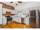 Bright kitchen with stainless steel appliances, white cabinets, and hardwood floors at 279 Delaware St, Denver, CO 80223