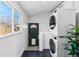Modern laundry room with stacked washer and dryer at 279 Delaware St, Denver, CO 80223