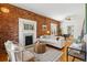 Cozy living room features exposed brick, fireplace, and comfortable seating at 279 Delaware St, Denver, CO 80223