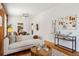Bright living room with white sofa, wood floors, and view into the dining area at 279 Delaware St, Denver, CO 80223