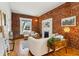 Stylish living room with exposed brick wall, fireplace, and lots of natural light at 279 Delaware St, Denver, CO 80223