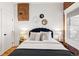 Comfortable main bedroom features warm wood floors, exposed brick and modern decor at 279 Delaware St, Denver, CO 80223