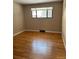 Bright bedroom featuring hardwood floors, a large window and neutral paint at 8542 W 10Th W Ave, Lakewood, CO 80215
