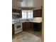 Functional kitchen featuring classic cabinetry, essential appliances, and a cozy breakfast nook at 8542 W 10Th W Ave, Lakewood, CO 80215