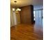 Spacious living area featuring gleaming hardwood floors, a partial brick wall and ample natural light at 8542 W 10Th W Ave, Lakewood, CO 80215