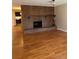 Inviting living room featuring a striking brick fireplace, complemented by gleaming hardwood floors at 8542 W 10Th W Ave, Lakewood, CO 80215