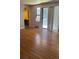 Sunny living room with gleaming wood floors, a sliding glass door and neutral paint at 8542 W 10Th W Ave, Lakewood, CO 80215