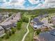 Wide aerial view of houses in a community with a walking path and surrounding green space at 3319 Starry Night Loop, Castle Rock, CO 80109