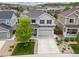 Aerial view of a gray two-story home with a large driveway and well-maintained landscaping at 3319 Starry Night Loop, Castle Rock, CO 80109