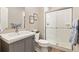 Well-lit bathroom with a glass-enclosed shower, gray vanity, and neutral decor at 3319 Starry Night Loop, Castle Rock, CO 80109