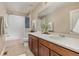 This bathroom features modern fixtures, a shower-tub combo, and plenty of counter space at 3319 Starry Night Loop, Castle Rock, CO 80109