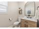 Well-lit bathroom with a sleek vanity, black faucet, and decorative shelves at 3319 Starry Night Loop, Castle Rock, CO 80109