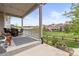 View from covered patio shows seating and a view of the grass and fence at 3319 Starry Night Loop, Castle Rock, CO 80109