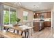 Open dining area with rustic wood table and benches, with sliding glass doors to outdoor space at 3319 Starry Night Loop, Castle Rock, CO 80109