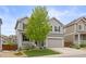 Beautifully landscaped front yard of this two-story home with a spacious two-car garage and welcoming porch at 3319 Starry Night Loop, Castle Rock, CO 80109
