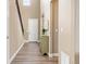 Bright and airy hallway with wood floors and views to rooms beyond at 3319 Starry Night Loop, Castle Rock, CO 80109