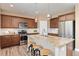 Stylish kitchen with granite island, stainless appliances, and shaker cabinets at 3319 Starry Night Loop, Castle Rock, CO 80109