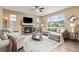 Cozy living room with a stone fireplace, comfortable seating, and natural light at 3319 Starry Night Loop, Castle Rock, CO 80109