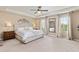 Spacious main bedroom featuring tray ceiling, large windows, and plush carpet at 3319 Starry Night Loop, Castle Rock, CO 80109