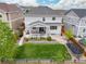 Aerial view of the backyard features a well-maintained lawn and covered porch at 3319 Starry Night Loop, Castle Rock, CO 80109