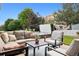 Backyard patio area with outdoor sofa, chairs, and a hot tub at 3540 Brushwood Dr, Castle Rock, CO 80109