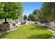 Landscaped backyard with a wooden deck, hot tub, built-in outdoor kitchen, and a well-manicured lawn at 3540 Brushwood Dr, Castle Rock, CO 80109