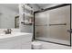 Bathroom featuring a shower, with a glass door, and floating shelves at 3540 Brushwood Dr, Castle Rock, CO 80109