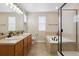 Spacious bathroom features a double sink vanity, soaking tub, and walk-in shower with glass door at 3540 Brushwood Dr, Castle Rock, CO 80109