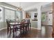 Inviting dining room with chandelier lighting, hardwood floors, and view into den at 3540 Brushwood Dr, Castle Rock, CO 80109