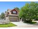 Inviting home with a two car garage, a covered porch, and a manicured lawn at 3540 Brushwood Dr, Castle Rock, CO 80109