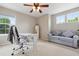 Bright home office with desk, chair, sofa, ceiling fan, and three windows with natural light at 3540 Brushwood Dr, Castle Rock, CO 80109