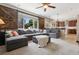 Bright living room featuring a large gray sectional sofa, barn door shutters, and an open floor plan at 3540 Brushwood Dr, Castle Rock, CO 80109