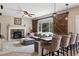 Bright living room featuring a stone fireplace, large window, and comfortable seating at 3540 Brushwood Dr, Castle Rock, CO 80109