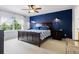 Comfortable primary bedroom featuring a dark wood bed frame, ceiling fan, and natural light at 3540 Brushwood Dr, Castle Rock, CO 80109