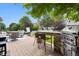 Cozy deck with a built-in outdoor kitchen, seating area, and hot tub, perfect for backyard entertaining at 3540 Brushwood Dr, Castle Rock, CO 80109
