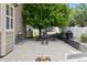 Large concrete backyard patio featuring outdoor seating, a built-in outdoor kitchen and lawn games at 3540 Brushwood Dr, Castle Rock, CO 80109