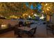 Cozy outdoor patio with fire pit, dining table, and string lights perfect for evening gatherings at 3540 Brushwood Dr, Castle Rock, CO 80109
