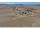 Lush countryside with scattered residences, barns, and outbuildings surrounded by rolling hills at 11810 Mesa View Rd, Larkspur, CO 80118