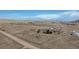 Wide aerial perspective showcases a rural property with multiple outbuildings and open fields at 11810 Mesa View Rd, Larkspur, CO 80118