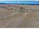 Expansive rural acreage with homes, barns, and outbuildings amidst open fields and distant mountain ranges at 11810 Mesa View Rd, Larkspur, CO 80118