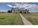 Inviting backyard with lush lawn, hot tub, and patio area, perfect for outdoor relaxation and entertainment at 11810 Mesa View Rd, Larkspur, CO 80118