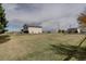 Expansive backyard featuring a lush lawn and mature trees, offering ample space at 11810 Mesa View Rd, Larkspur, CO 80118