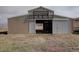 View of the barn with sliding door, providing ample space for animals and equipment at 11810 Mesa View Rd, Larkspur, CO 80118