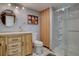 Bright bathroom featuring updated fixtures, a glass enclosed shower, and ample storage at 11810 Mesa View Rd, Larkspur, CO 80118