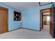 Bedroom with light blue walls, decorative window, neutral carpet, and wood trim at 11810 Mesa View Rd, Larkspur, CO 80118