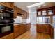 Bright kitchen with wooden cabinets, granite counters, tiled backsplash, and stainless steel appliances at 11810 Mesa View Rd, Larkspur, CO 80118