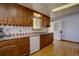 Well-lit kitchen boasts granite counters, wooden cabinetry, tiled backsplash, and modern dishwasher at 11810 Mesa View Rd, Larkspur, CO 80118