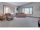 Comfortable living room with large windows offering scenic views, plush seating, and natural light at 11810 Mesa View Rd, Larkspur, CO 80118